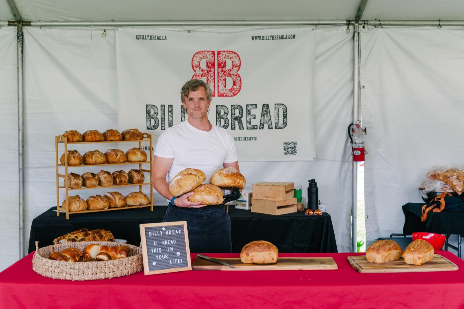 Billy Lush holding fresh-baked sourdough loaves at Billy Bread in Newbury Park